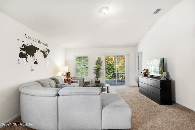 carpeted living room featuring lofted ceiling