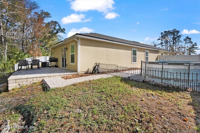 view of side of property with a patio area