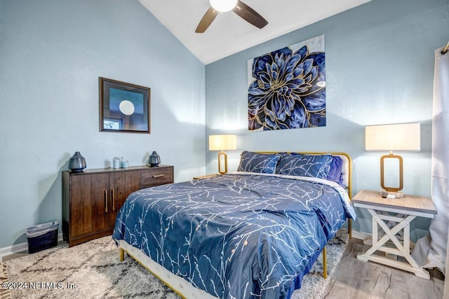 bedroom with hardwood / wood-style floors, ceiling fan, and lofted ceiling