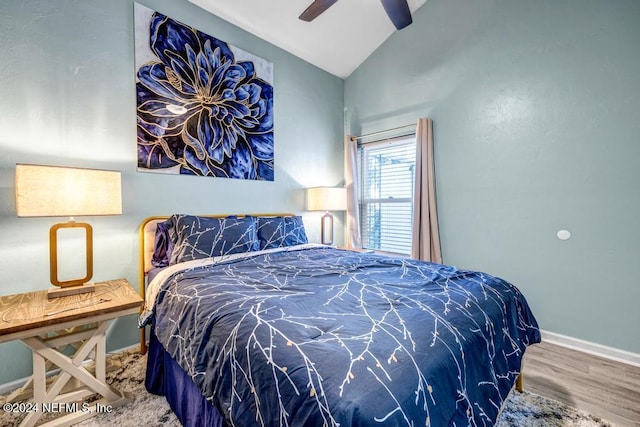 bedroom featuring hardwood / wood-style floors, ceiling fan, and lofted ceiling