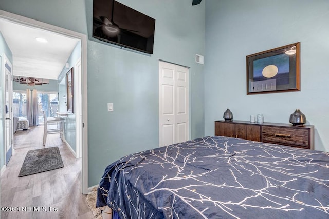 bedroom with light hardwood / wood-style flooring and a closet