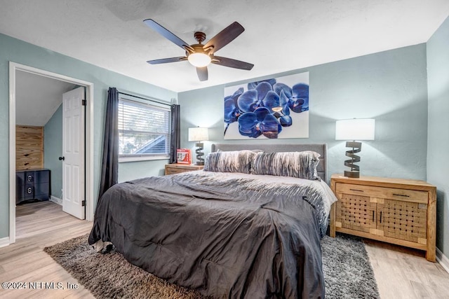 bedroom with ceiling fan and light wood-type flooring