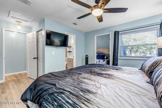 bedroom with ensuite bathroom, ceiling fan, and light hardwood / wood-style floors