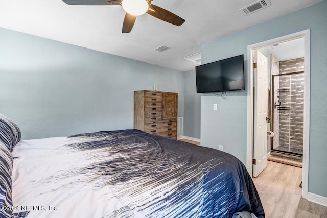 bedroom with light wood-type flooring, connected bathroom, and ceiling fan