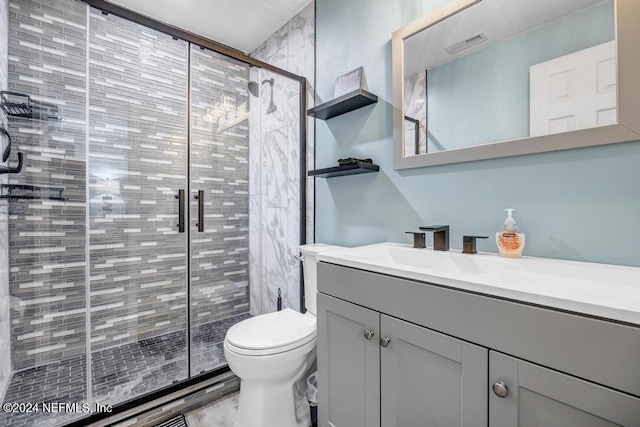 bathroom with walk in shower, vanity, and toilet