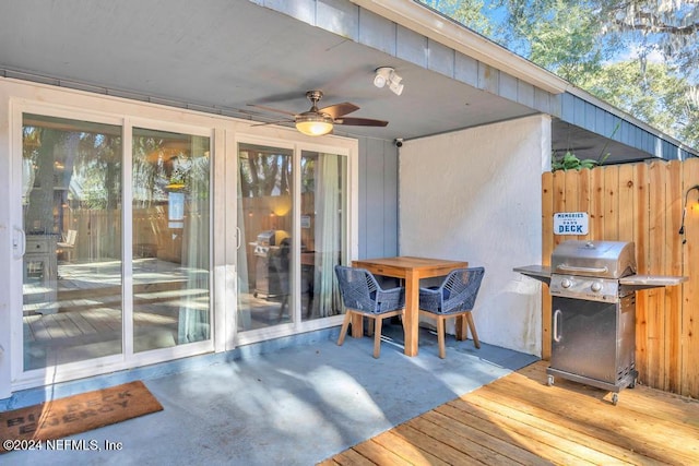 deck with ceiling fan, a patio, and grilling area