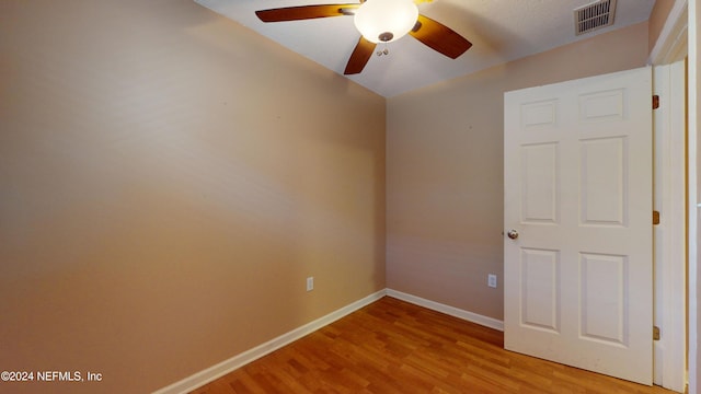 empty room featuring ceiling fan and light wood-type flooring