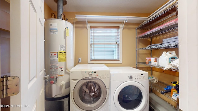 laundry area featuring washer and dryer, a textured ceiling, and water heater