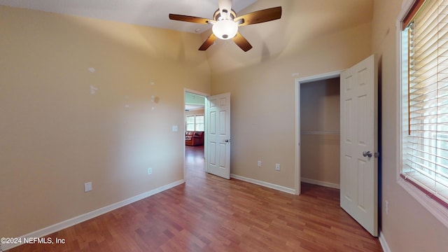 unfurnished bedroom featuring multiple windows, ceiling fan, and light hardwood / wood-style flooring