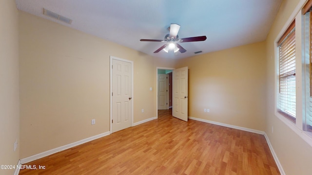 unfurnished bedroom featuring light wood-type flooring and ceiling fan