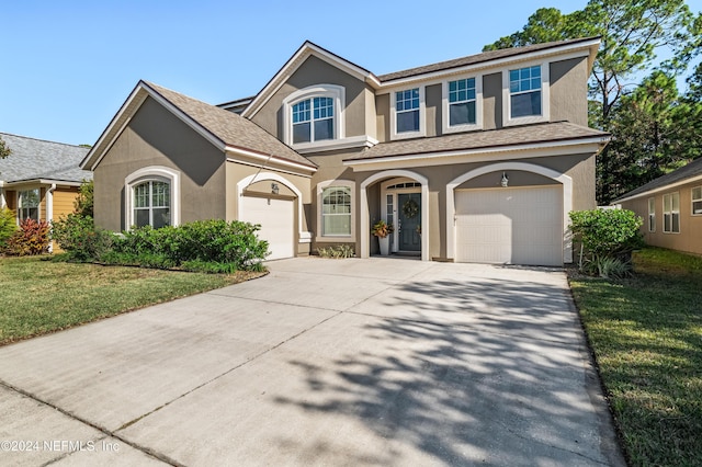 view of front facade with a front yard and a garage