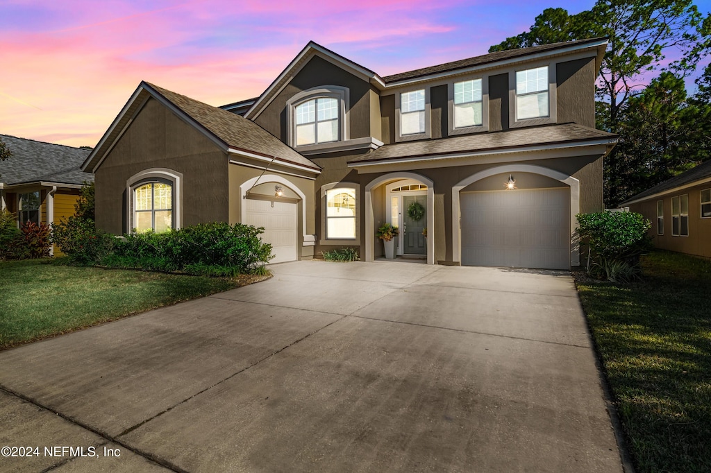 view of front of home featuring a yard and a garage