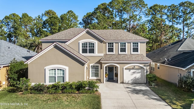 view of property with a front yard and a garage