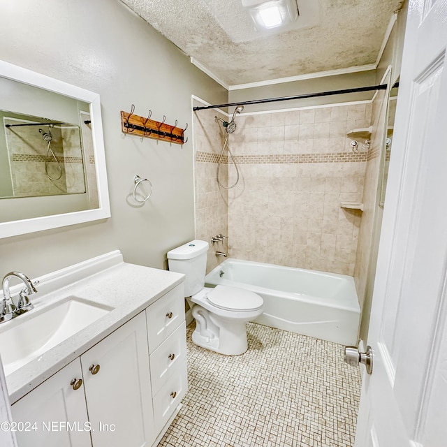 full bathroom with vanity, toilet, a textured ceiling, and tiled shower / bath