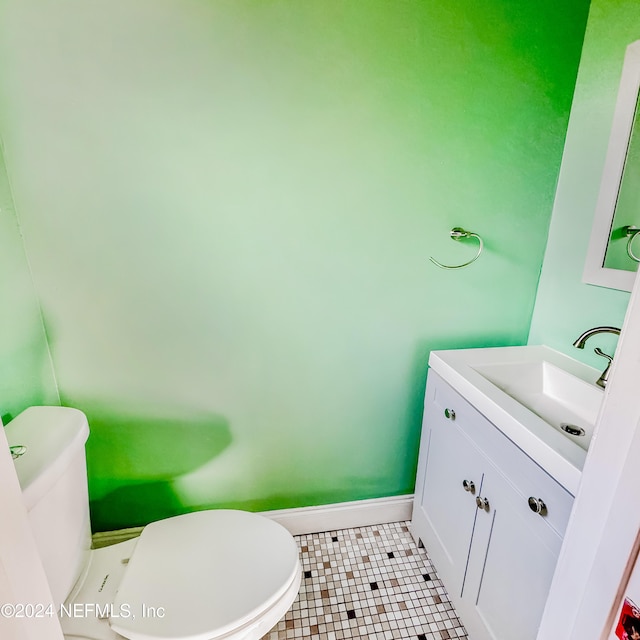 bathroom featuring toilet, vanity, and tile patterned floors