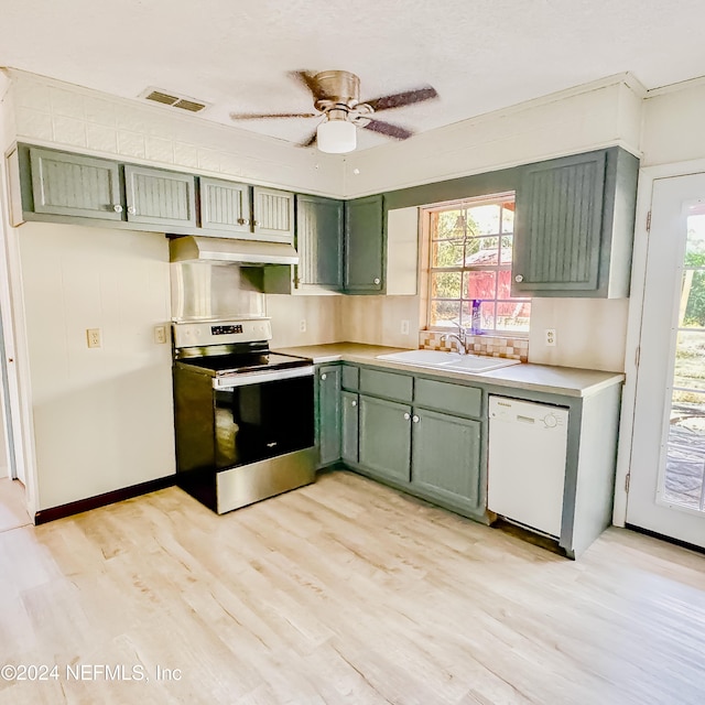 kitchen with green cabinets, sink, white dishwasher, and stainless steel range oven