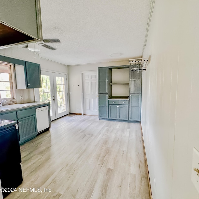 kitchen featuring french doors, a textured ceiling, white dishwasher, sink, and light hardwood / wood-style flooring