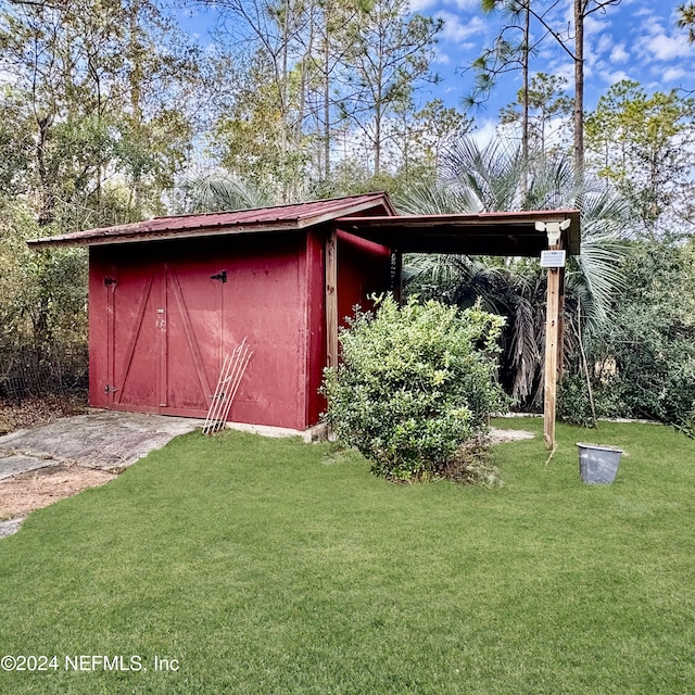 view of outbuilding featuring a lawn