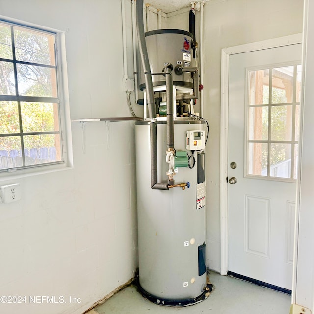 utility room featuring water heater