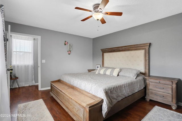 bedroom with ceiling fan and dark hardwood / wood-style flooring