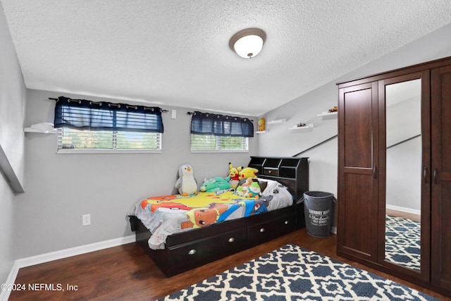 bedroom featuring hardwood / wood-style floors and a textured ceiling