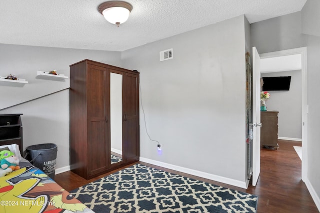 office area featuring lofted ceiling, a textured ceiling, and dark wood-type flooring