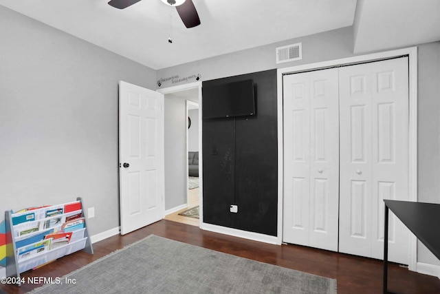 bedroom featuring a closet, ceiling fan, and dark hardwood / wood-style flooring