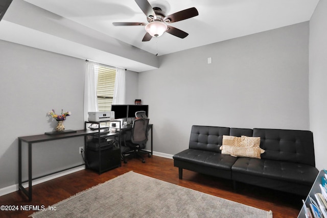 home office with ceiling fan and dark hardwood / wood-style flooring