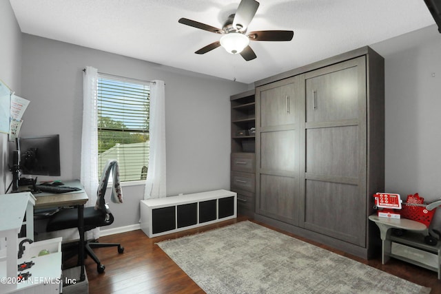 office area featuring a textured ceiling, ceiling fan, and dark wood-type flooring