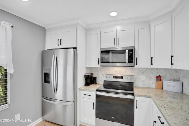 kitchen featuring white cabinets, light stone countertops, and appliances with stainless steel finishes