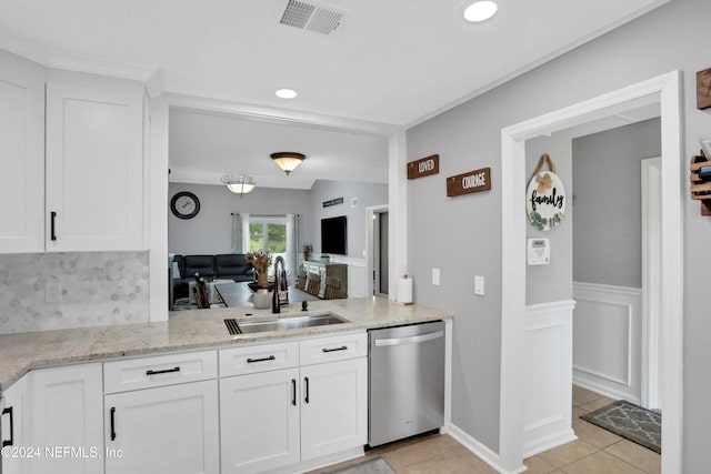 kitchen featuring dishwasher, light tile patterned floors, white cabinetry, and sink