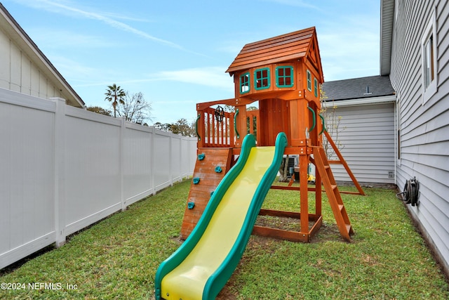 view of jungle gym with a lawn