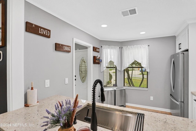 exercise room featuring crown molding and sink