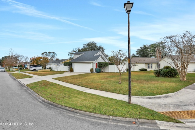 single story home with a garage and a front yard