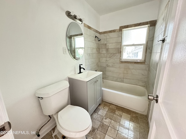 full bathroom with toilet, vanity, and tiled shower / bath combo