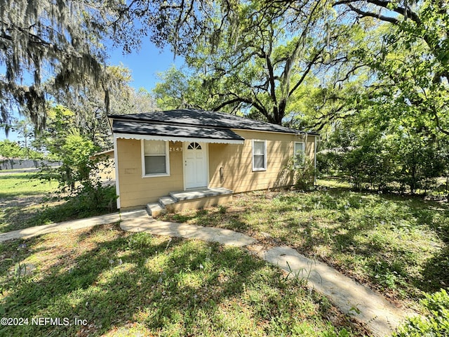 bungalow-style home with a front yard