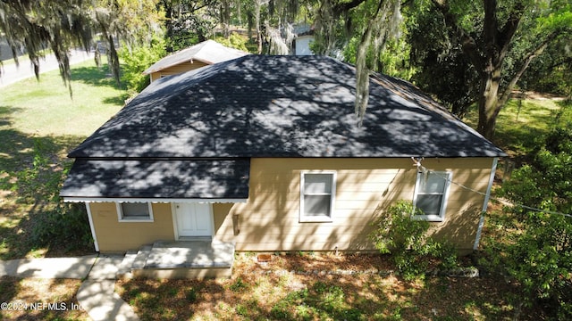 rear view of house featuring a lawn