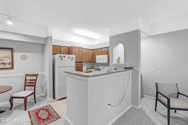 8550 Touchton Rd Unit 1226, Jacksonville, FL 32216 - kitchen featuring crown molding, white appliances, and kitchen peninsula