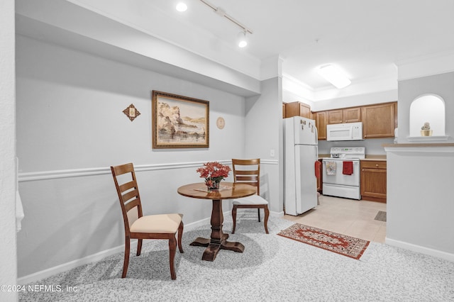 8550 Touchton Rd Unit 1226, Jacksonville, FL 32216 - kitchen with crown molding, light tile patterned flooring, white appliances, and rail lighting