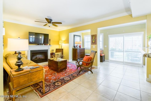 living room with crown molding, ceiling fan, and light tile patterned floors