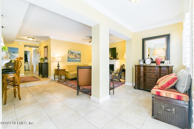 interior space with ceiling fan and crown molding