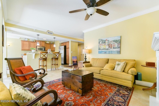 tiled living room with ceiling fan and ornamental molding