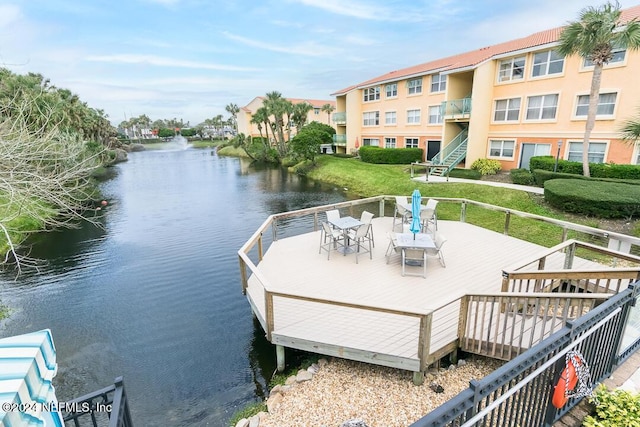 view of dock featuring a deck with water view