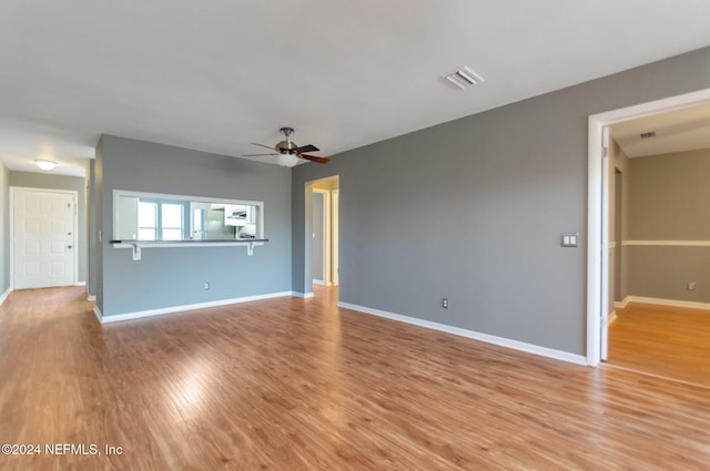 unfurnished living room featuring ceiling fan and light wood-type flooring