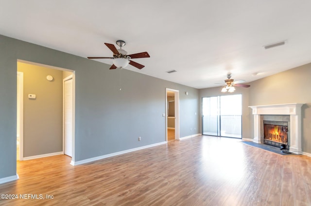 unfurnished living room with light hardwood / wood-style flooring and ceiling fan