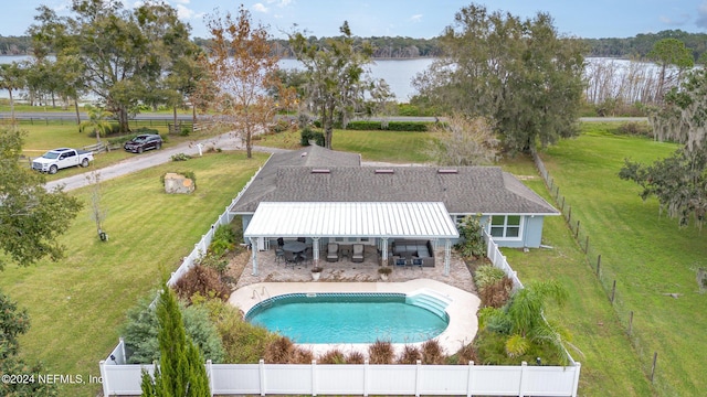 view of swimming pool with a water view and a patio