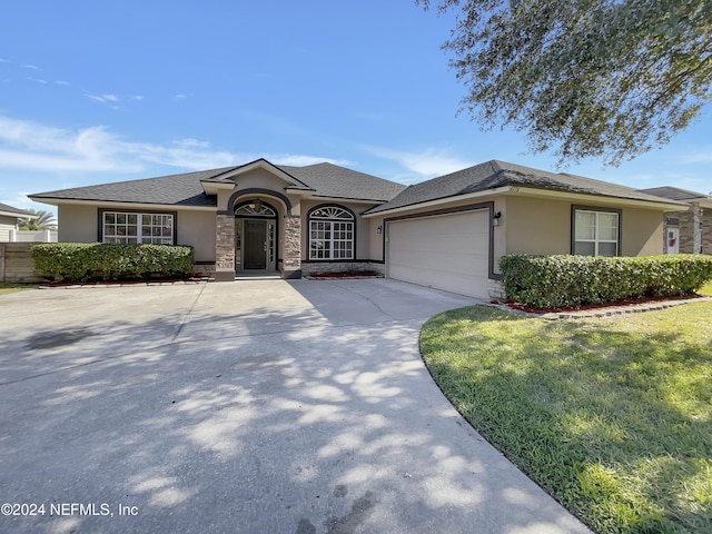 view of front of home with a front yard and a garage