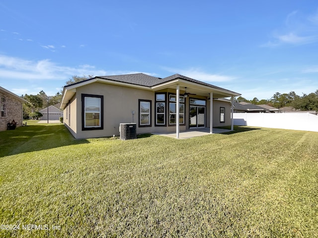 rear view of house with central AC, a yard, and a patio