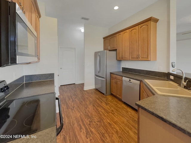 kitchen with sink, stainless steel appliances, and dark hardwood / wood-style floors