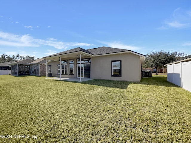 rear view of property with a patio area and a yard